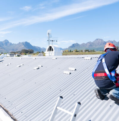worker diagnosing a commercial roof leak