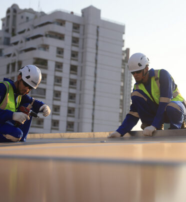 workers fixing an emergency commercial roof leak