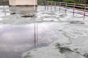 apartment roof with ponding water requiring leak repairs