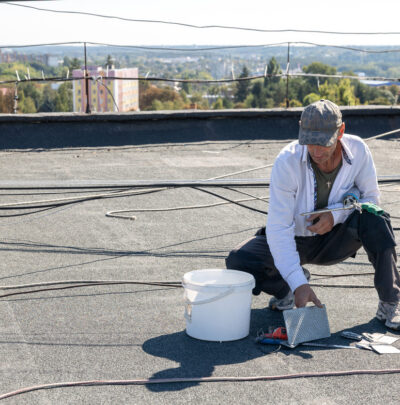 man performing commercial roof leak repair