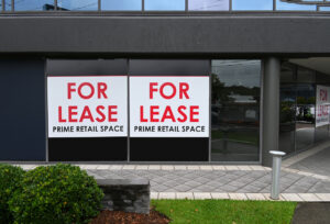 retail space with "for lease" sign after roof leak water damage