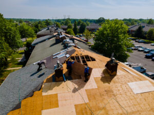 workers replacing an apartment building roof