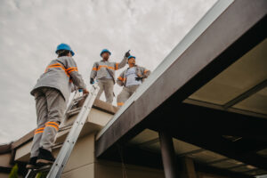 workers performing a roof inspection at a school