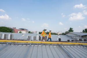 roofers doing a multifamily building roof assessment