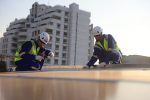 workers performing roof maintenance on an office building