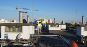 workers performing a hospital roof inspection