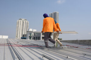 roofing workers installing a new roof at an industrial building