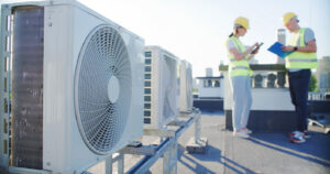 workers performing roof maintenance at an industrial building