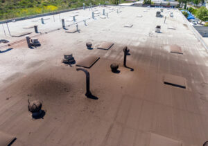 Image of a commercial roof with visible discoloration and damage